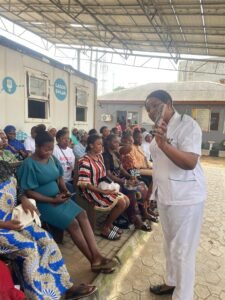 A senior Health practitioner addressing the women